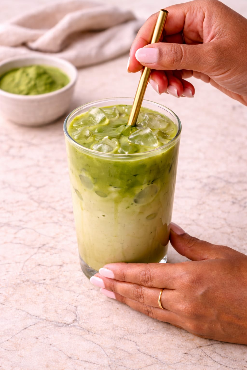 Step 5: Stirring an iced matcha oat milk latte until fully combined