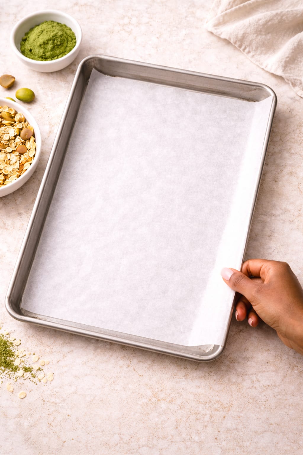 Step 1: Lining a baking sheet with parchment paper for oven-baked matcha granola