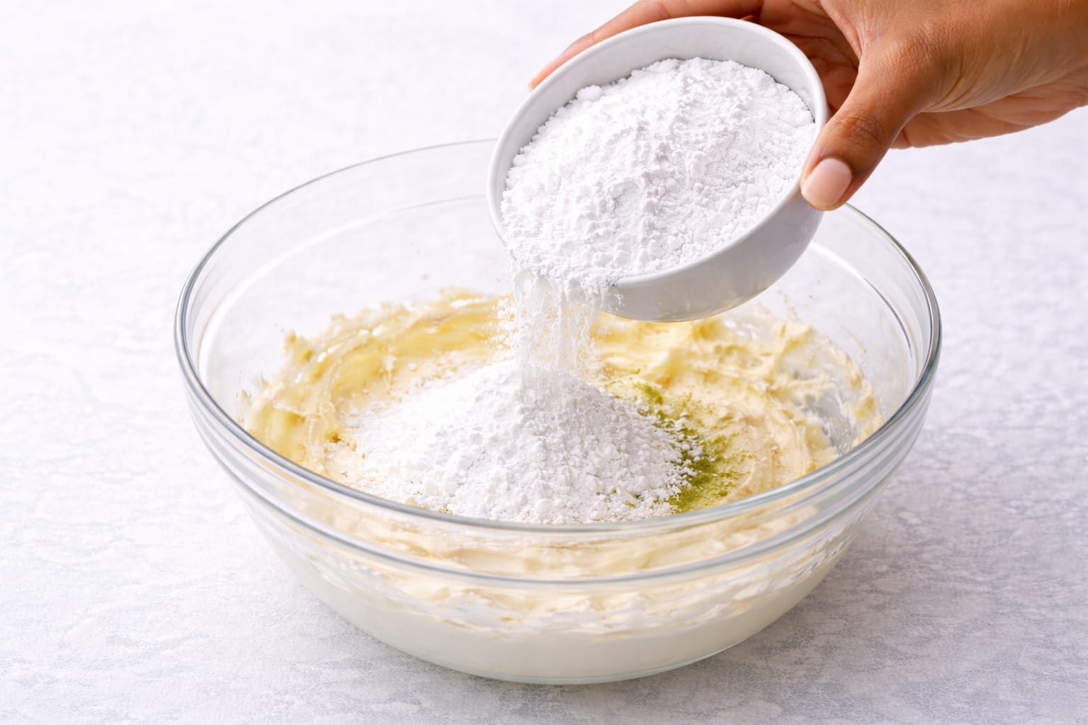 Step 3: Mixing powdered sugar into matcha cream cheese frosting