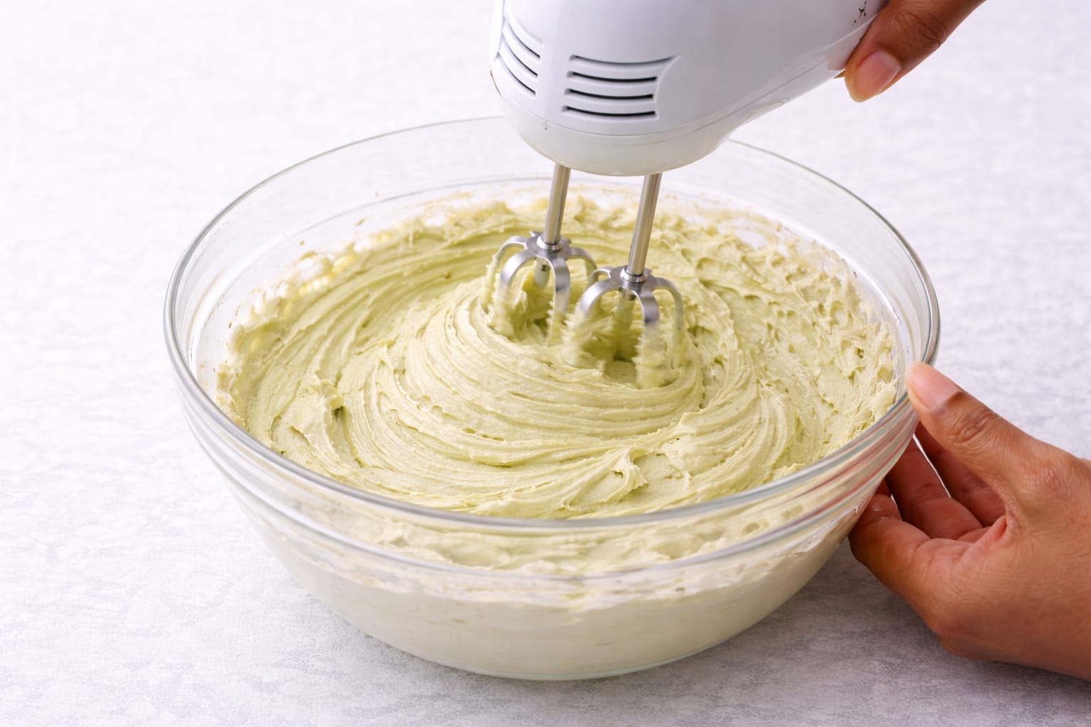 Step 4: Adding vanilla and cream to matcha cream cheese frosting